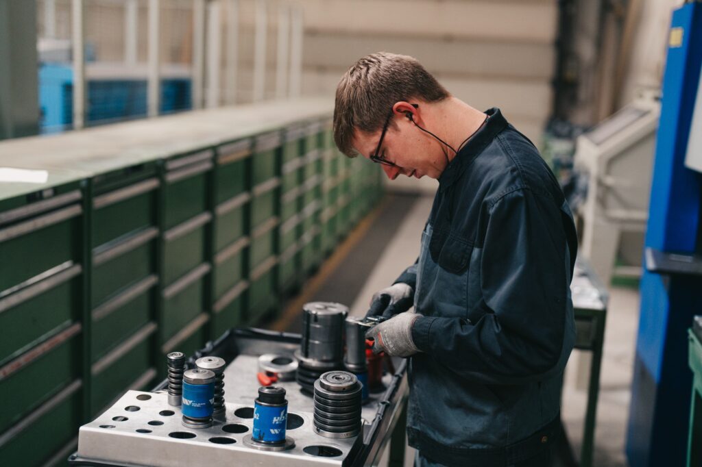 Persoon die onderhoud uitvoert aan een machine.